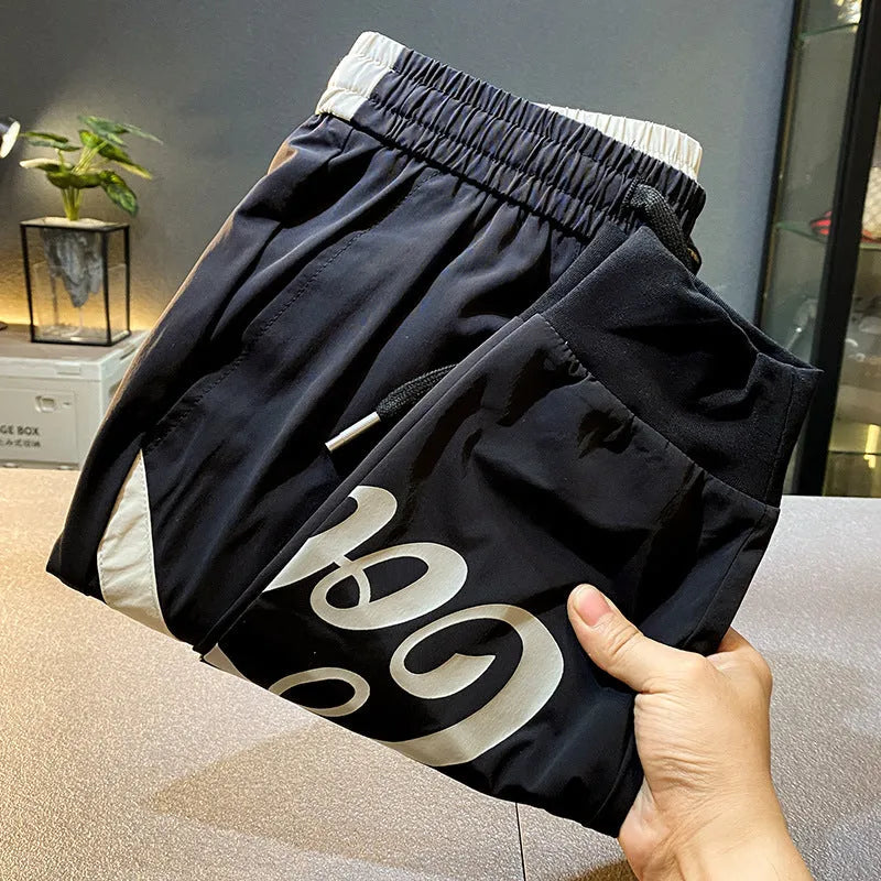 Black men's cropped casual trousers with ankle band made from ultra-thin ice silk cotton fabric.