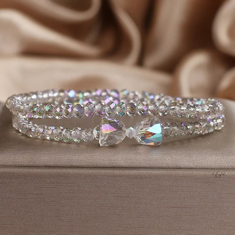 Women's double-circle crystal bow bracelet in white, green, and pink colour options on display