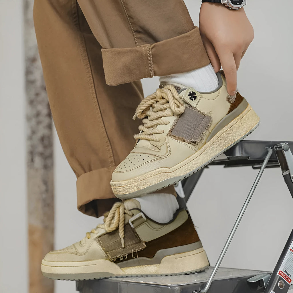 Beige low-top casual skateboard shoes with round toe and front lace-up on a rubber sole.