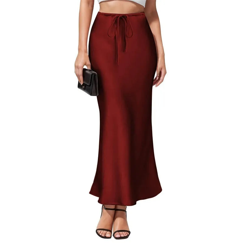 Women's high-waist asymmetric satin skirt in black with irregular stitching detail on the hem.