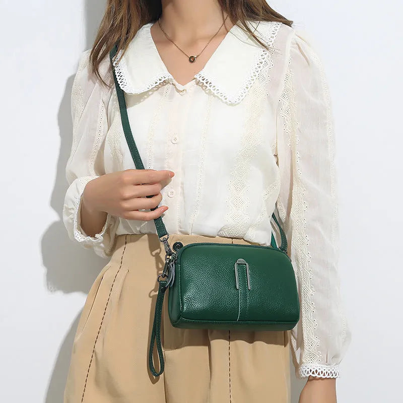 Genuine leather women's square shoulder bag in dark green, showing its horizontal 19x13x6cm shape.