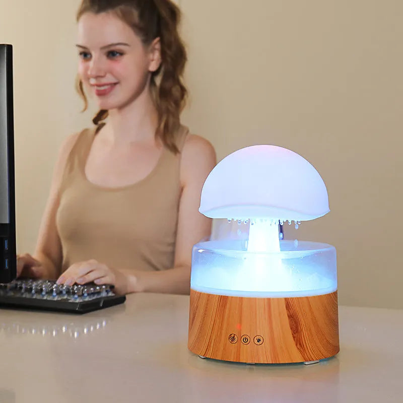 White cloud-shaped humidifier with falling raindrop effect and colour-changing LED lights