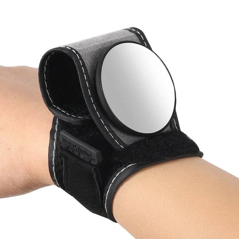 Black nylon wrist-mounted rear-view mirror for cyclists and motorcyclists on a textured background.