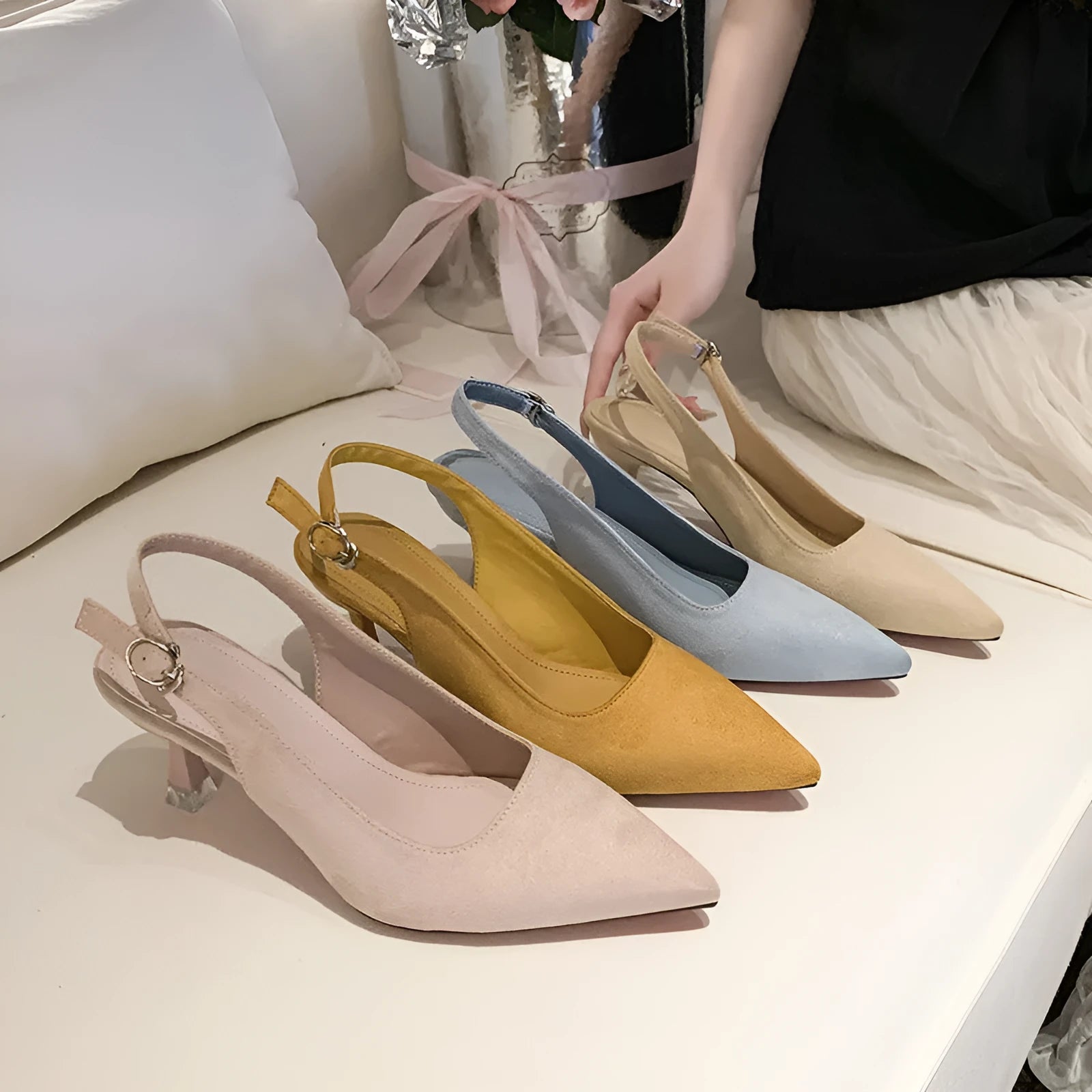 Apricot suede stiletto high heels with a pointed toe and rubber sole on a plain background.