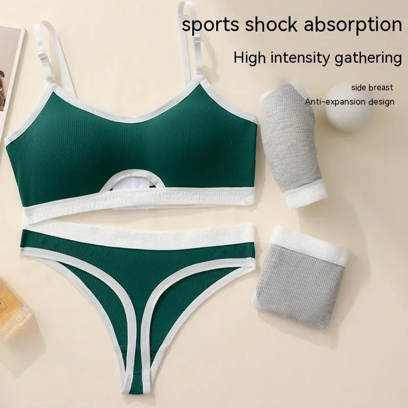 Women's contrast back sports bra vest and briefs set in black with underwire and padding.