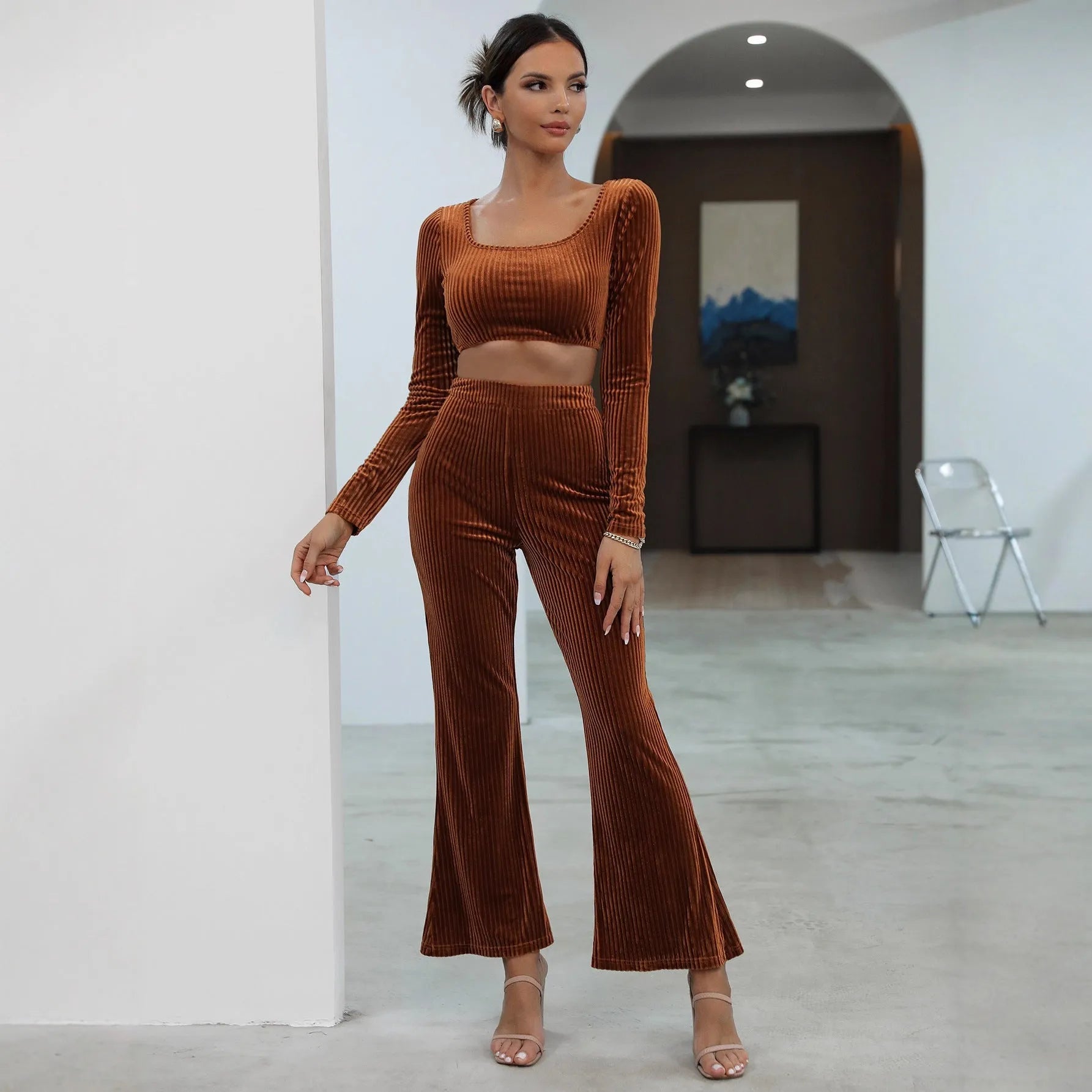 Caramel coloured long sleeve sweater and matching trousers lounge set on a hanger