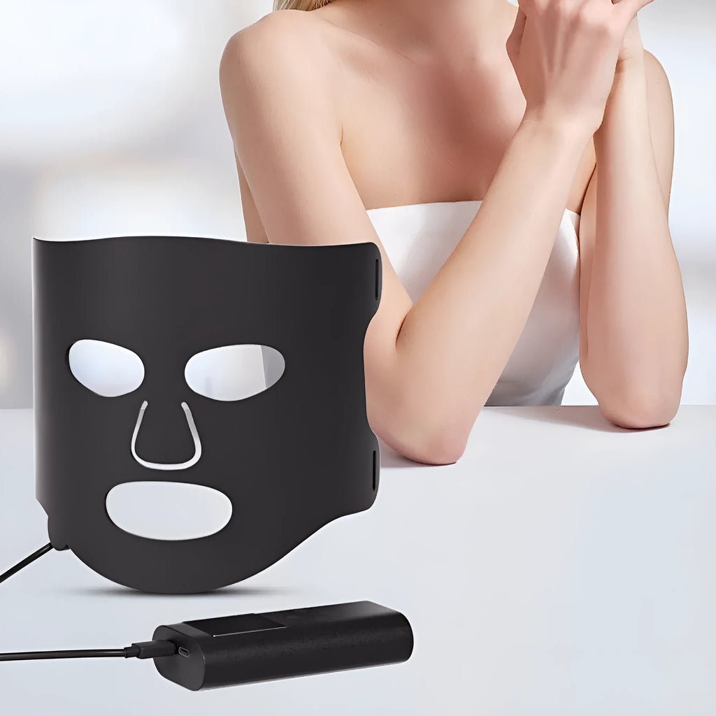 Black and gold LED phototherapy face mask with controller, shown with its USB charging cable.
