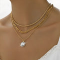 Gold multi-layer pendant necklace with large hemp flowers chain and geometric round pendant on woman