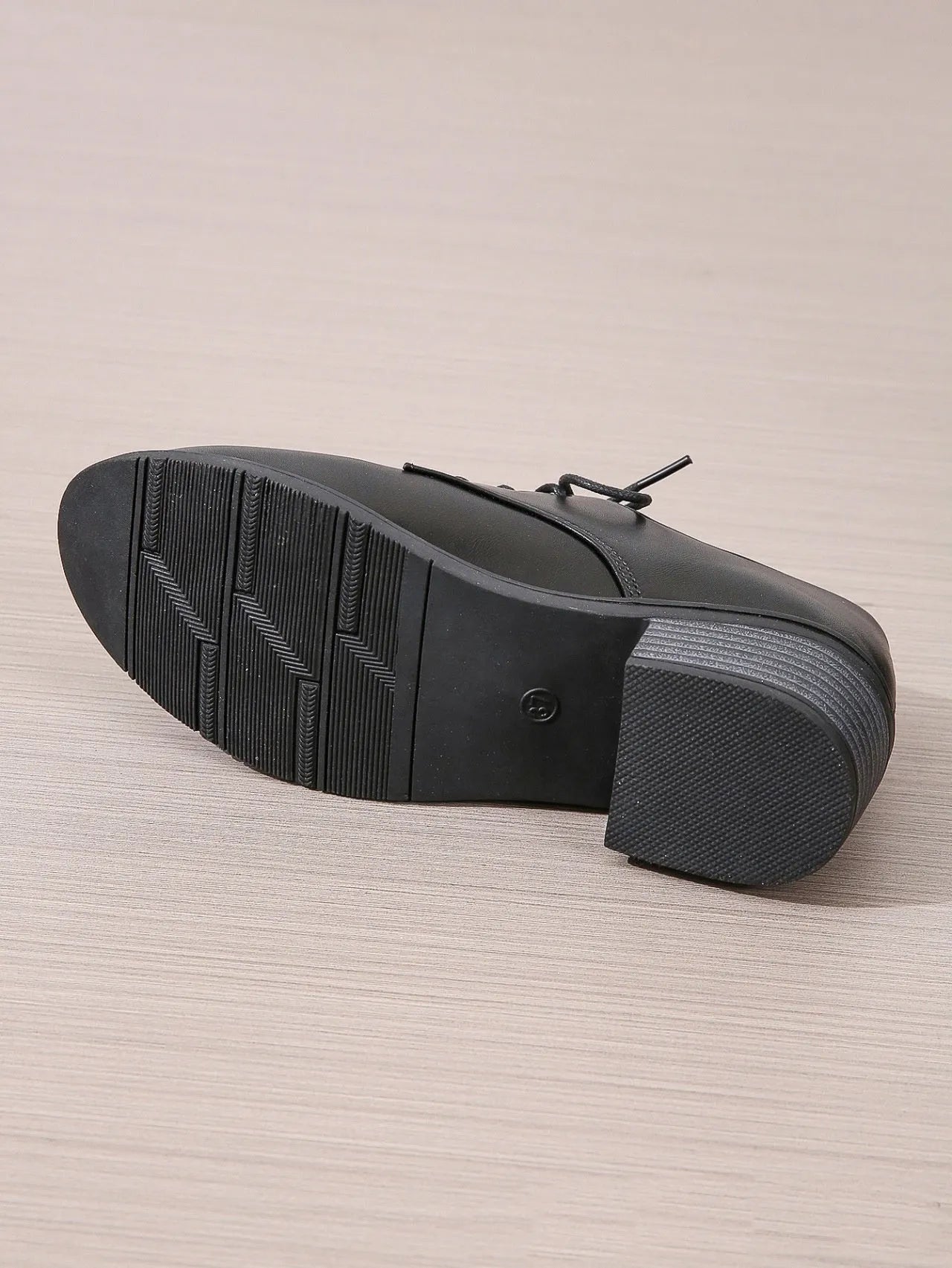 Black women's low-top slip-on work shoes with a chunky mid-heel and rounded toe.