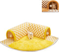 Brown plaid collapsible cat tunnel bed with a central mat on a wooden floor.