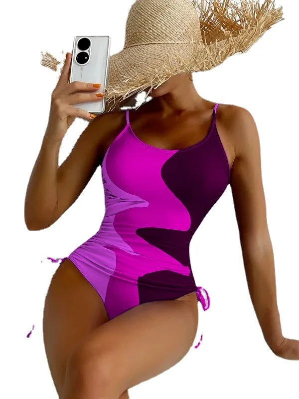 Blue women's sleeveless backless one-piece swimsuit with a striped print, made from polyester and nylon fabric.