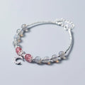 Handmade adjustable bracelet with a natural moonstone and silver crescent moon charm on a wrist.