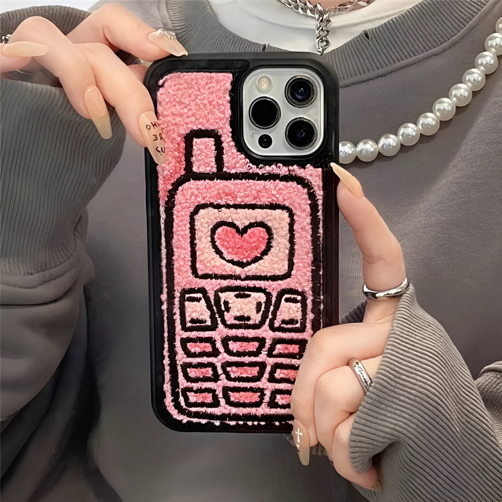 Pink towel embroidered TPU phone case for iPhone showing textured back surface and camera cutouts