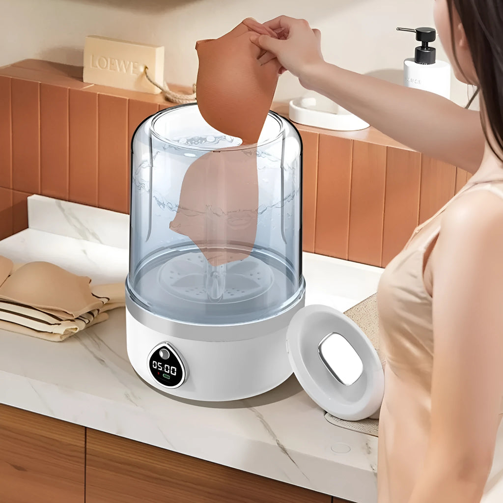White portable USB charging mini washing machine with compact plastic housing on a countertop.