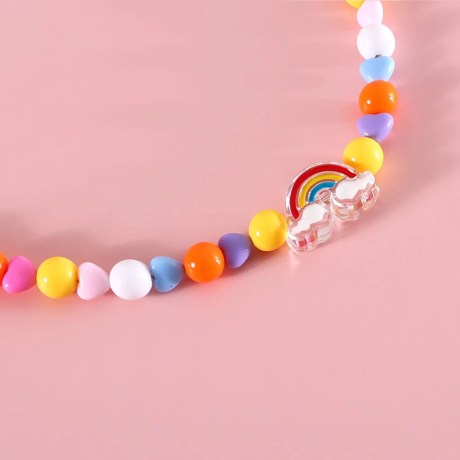 Colourful plastic bead cat necklace in small flower, rainbow, or peach design on a cat.