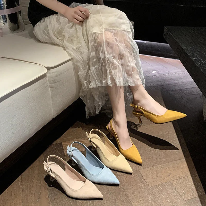 Apricot suede stiletto high heels with a pointed toe and rubber sole on a plain background.