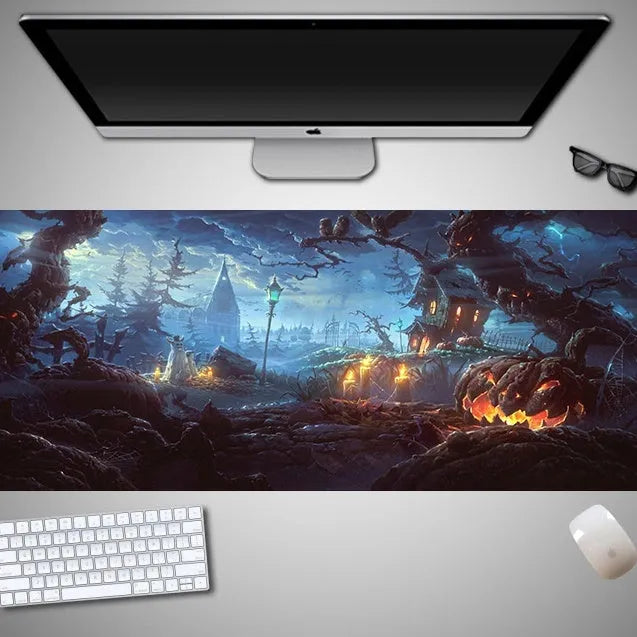 Oversized black Halloween-themed mouse pad with spooky artwork on a desk next to a gaming mouse.