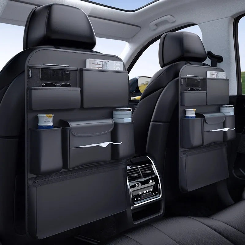 Black leather car seat back hanging storage bag with carrying handle shown in vehicle