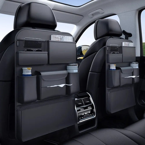 Black leather car seat back hanging storage bag with carrying handle shown in vehicle