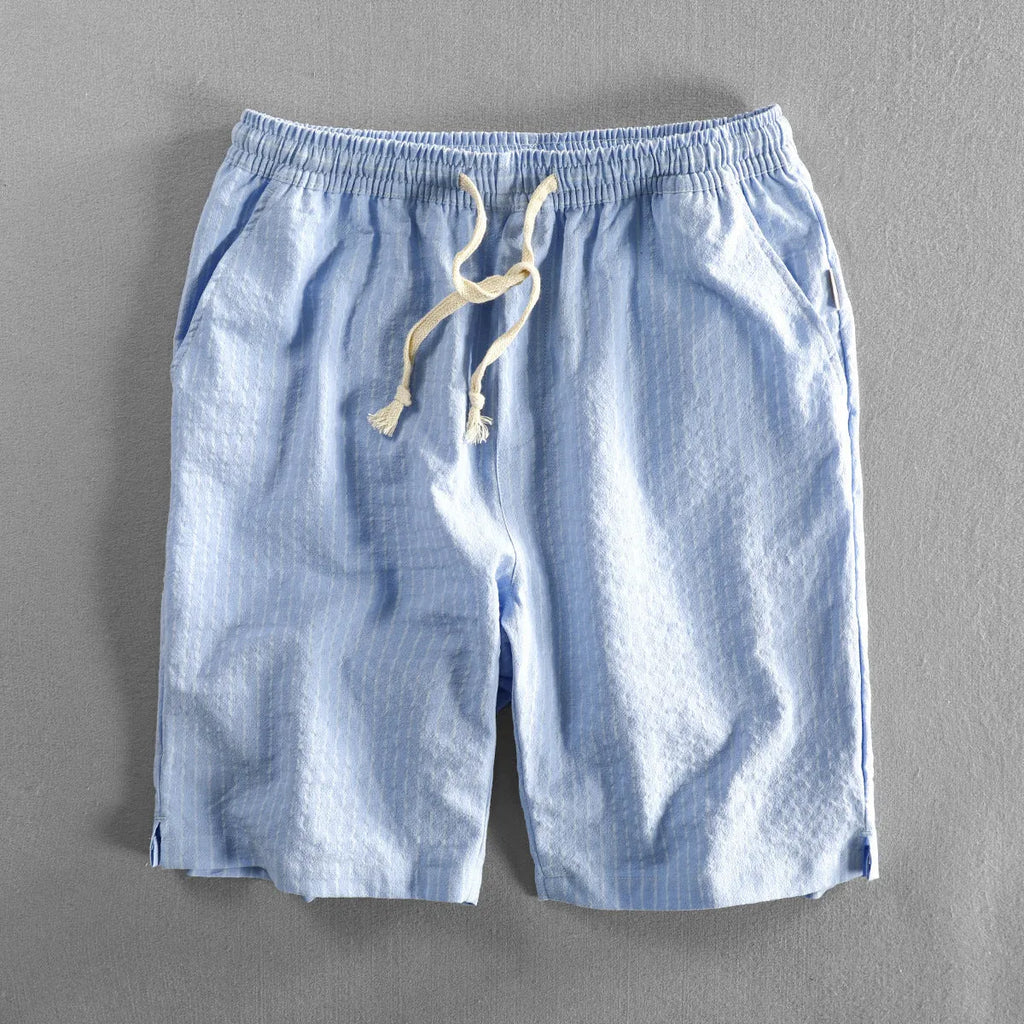 Men's striped cotton casual shorts in a loose straight fit on a mid-waist, shown in light blue colour.
