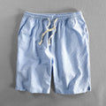 Men's striped cotton casual shorts in a loose straight fit on a mid-waist, shown in light blue colour.