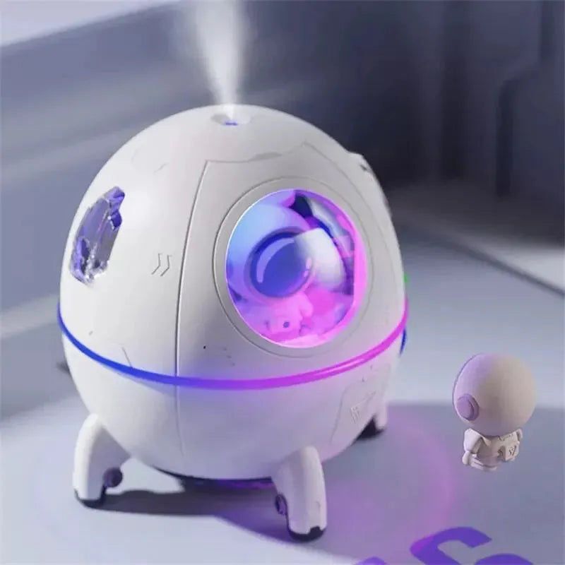 Light purple astronaut-themed USB humidifier with colourful LED lights on desktop