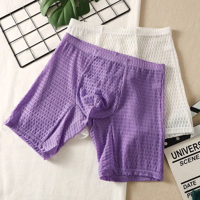 Men's solid colour lace boxer shorts on a white background, showing the textured fabric and hip-lifting shape.