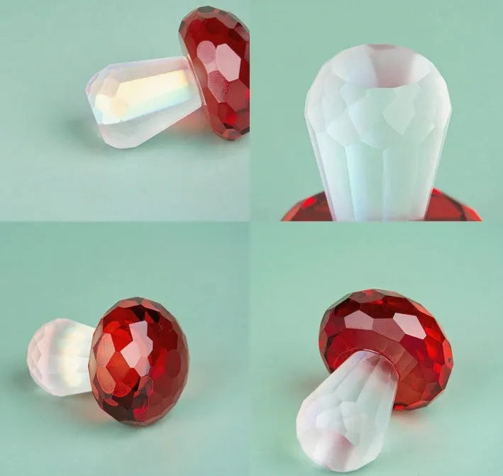 Set of four colourful crystal mushroom decorations in transparent, green, red, and yellow on a white background.