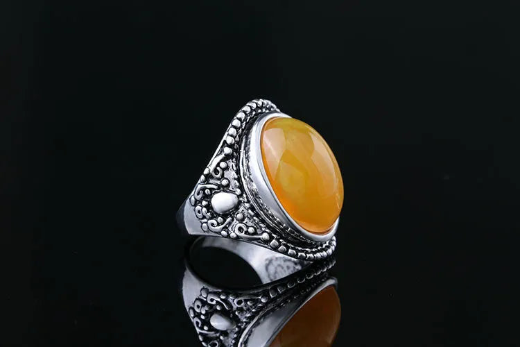 Geometric alloy ring with antique silver amber electroplated finish on a grey background.