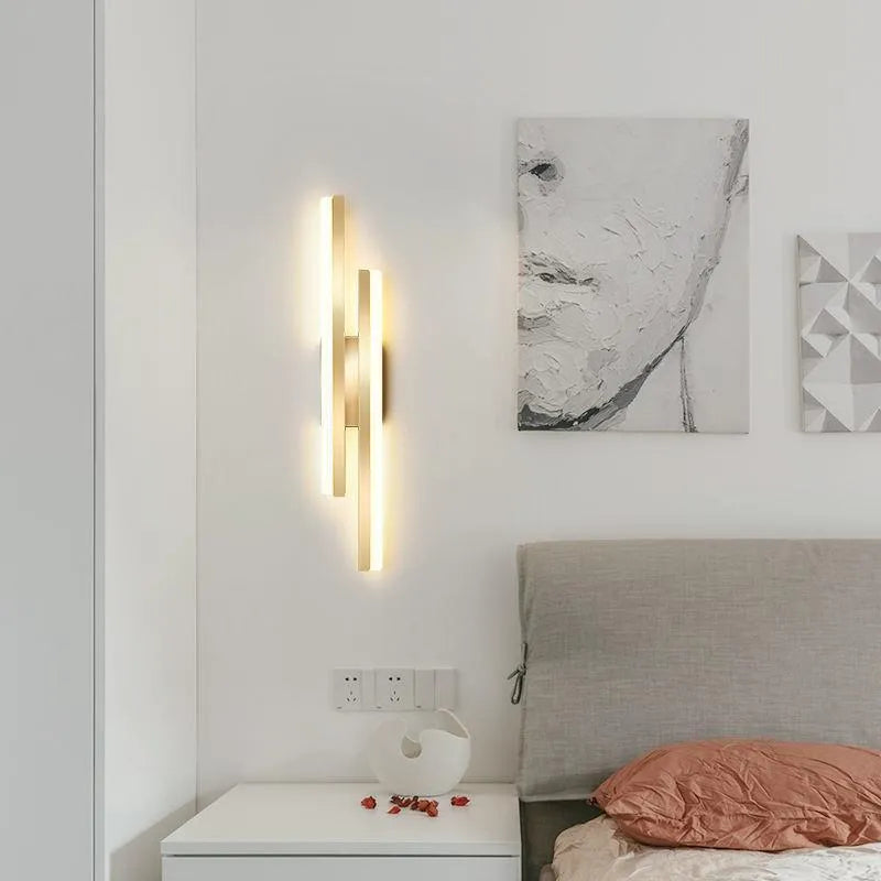 Modern Scandinavian minimalist LED wall light with acrylic shade in black or gold finish.