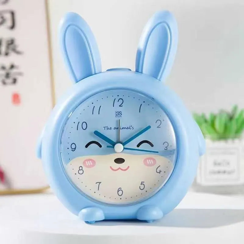 Pink and blue cartoon-style children's alarm clock showing night light and display