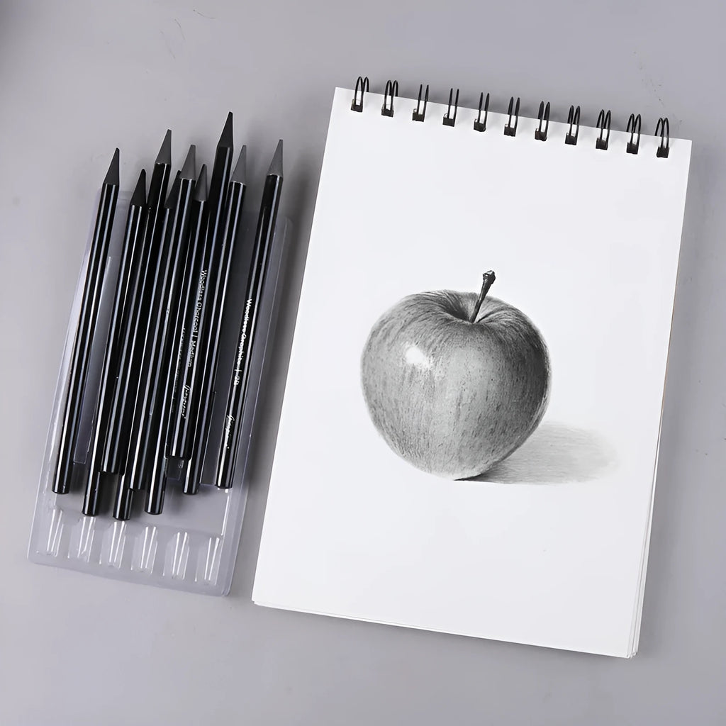 Set of six graphite and three carbonized drawing pencils with wooden casings on a suction card.