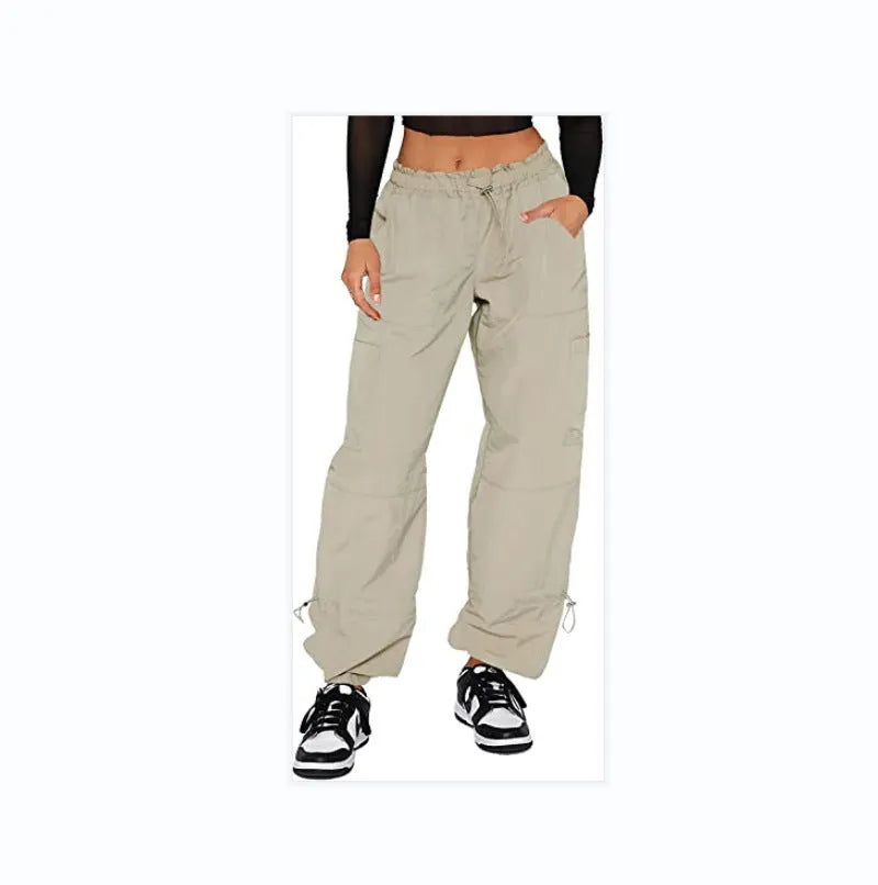 Man wearing loose grey straight-leg cargo casual pants with multiple pockets.