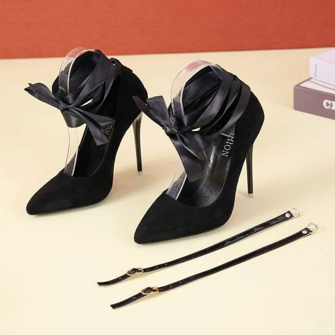 Black women's stiletto pump with thin lace strap and pointed toe on a 12cm heel.