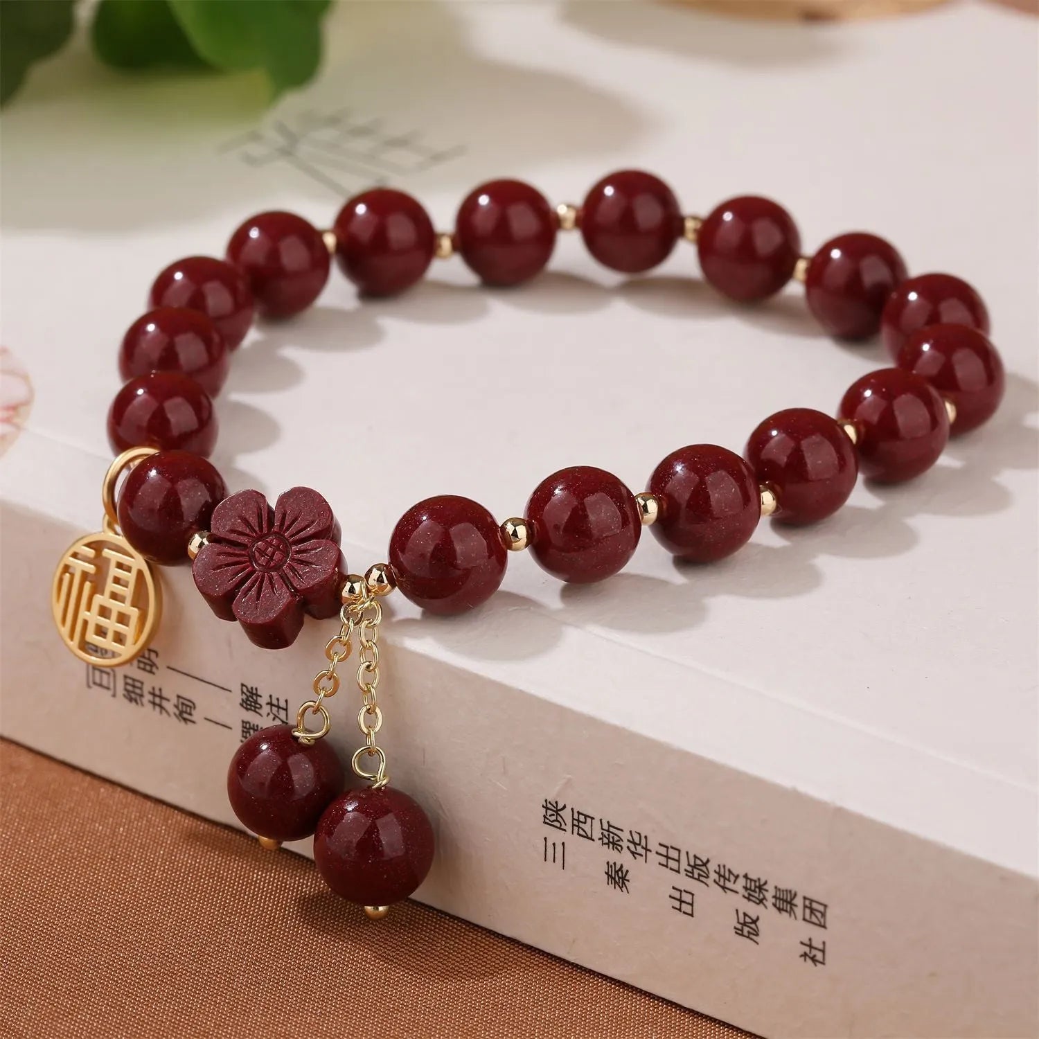 Women's national style cinnabar bracelet with fu character design and peach blossom tassel detailing