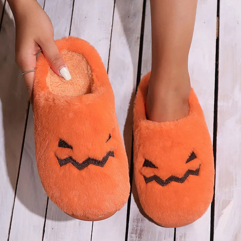 Orange coral velvet Halloween pumpkin slippers with plush lining and a grey non-slip PVC sole.