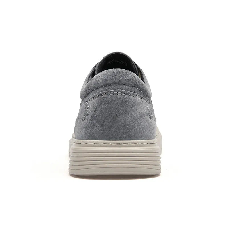 Men's grey casual skate shoes with pigskin upper and rubber sole showing lace-up front design