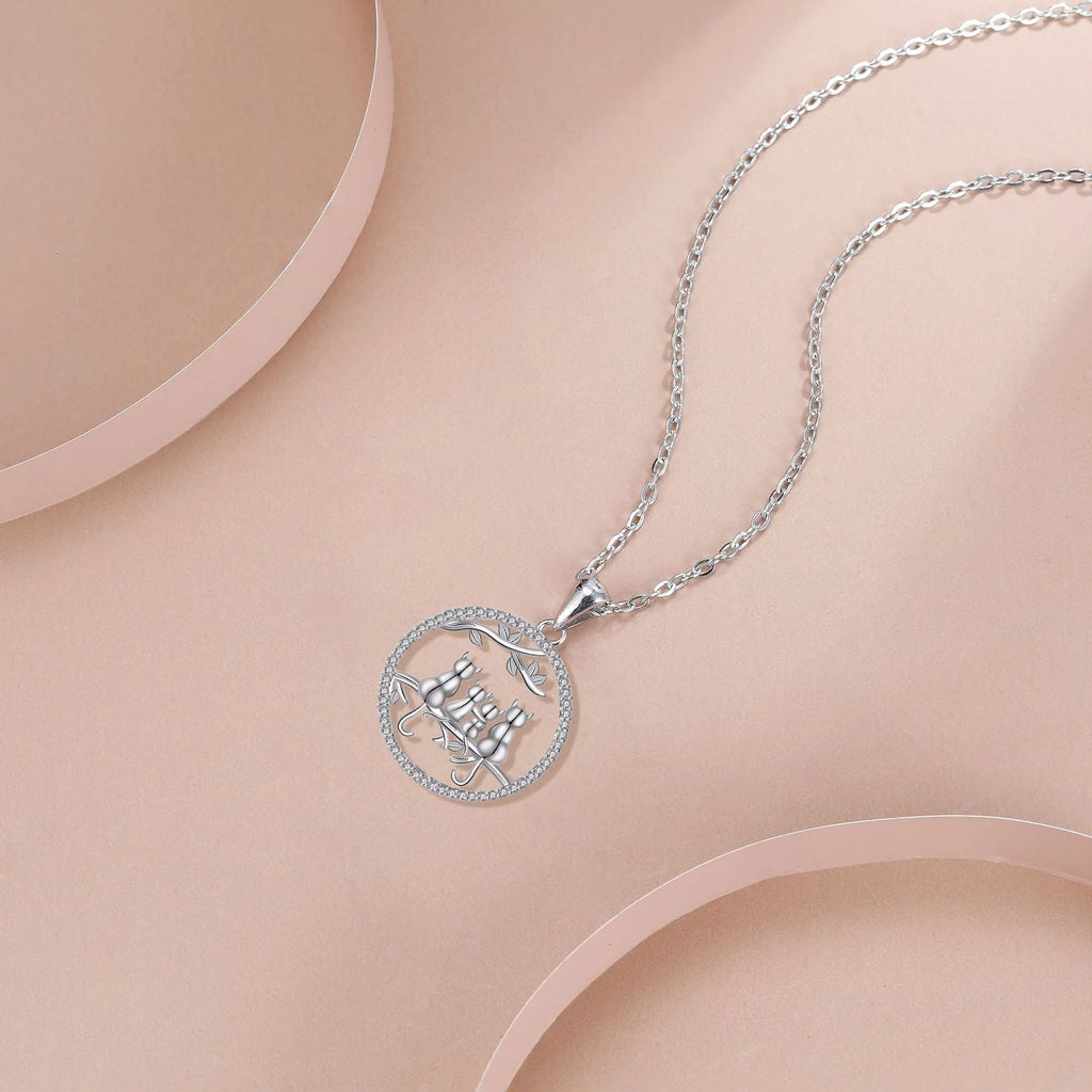 Women's silver-toned necklace with four kitten charms on cross chain