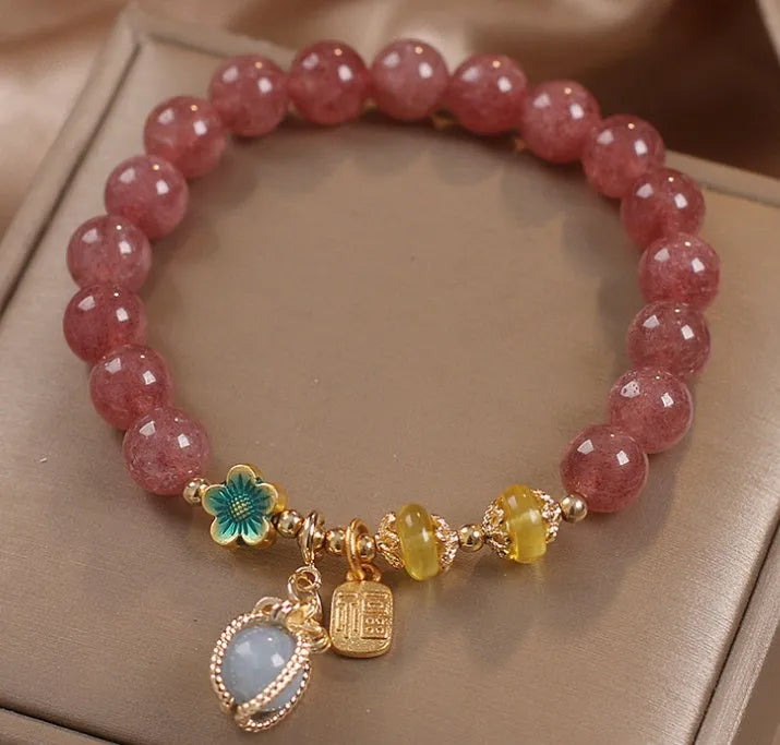 Red strawberry quartz beaded bracelet with alloy metal and rhinestone details