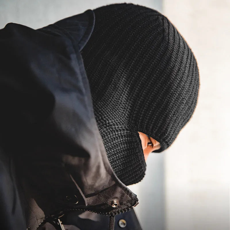 Vintage knitted melon skin warm beanie in black with patch detail on a plain background