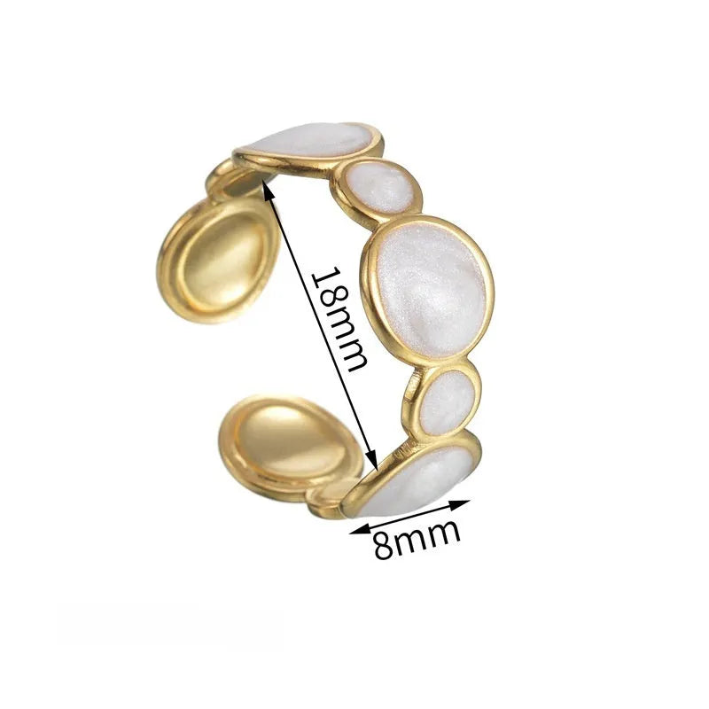 Women's silver geometric ring with an adjustable opening on a grey background.