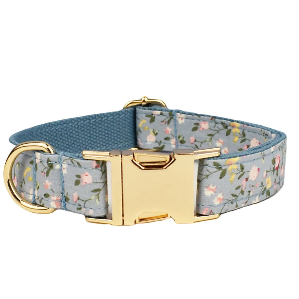 Blue floral pattern dog collar set with matching leash, bow, vest and waste bag dispenser accessories