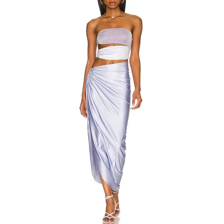 Purple one-piece swimsuit with a separate matching wrap skirt laid flat.