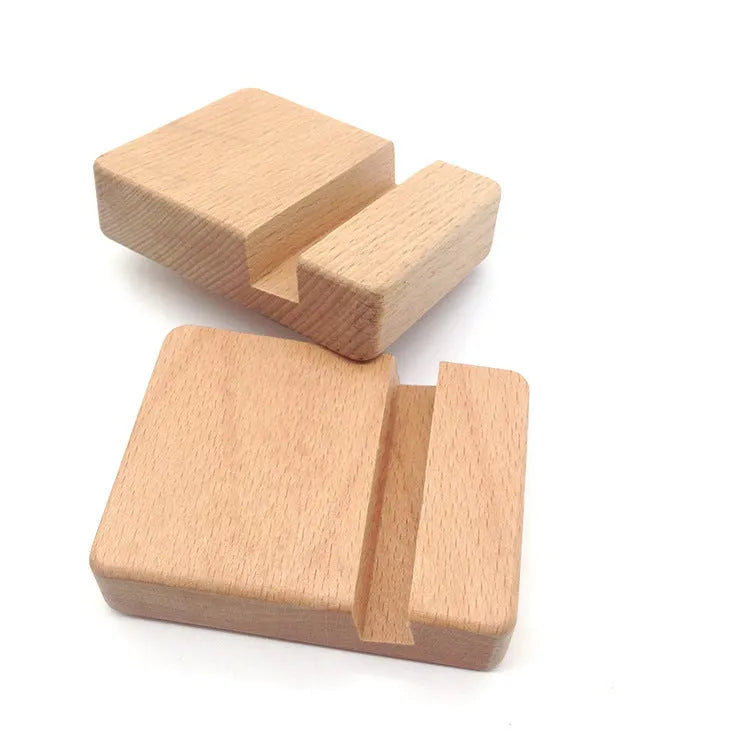 Beech wood mobile phone holder stand with coin slot and decorative carving.