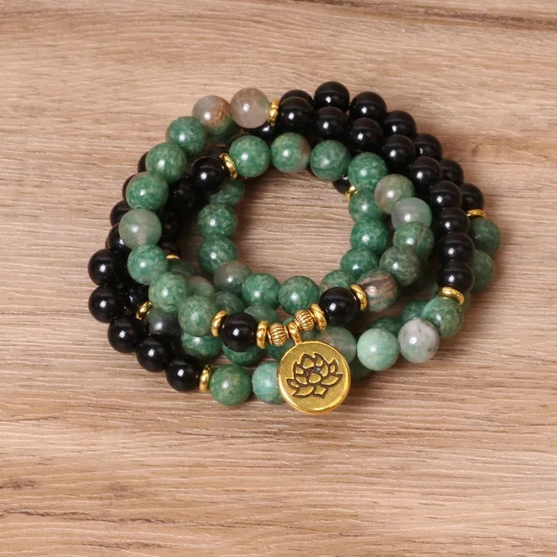Women's green and black alloy elastic beaded bracelet on a wrist, showing natural style design.