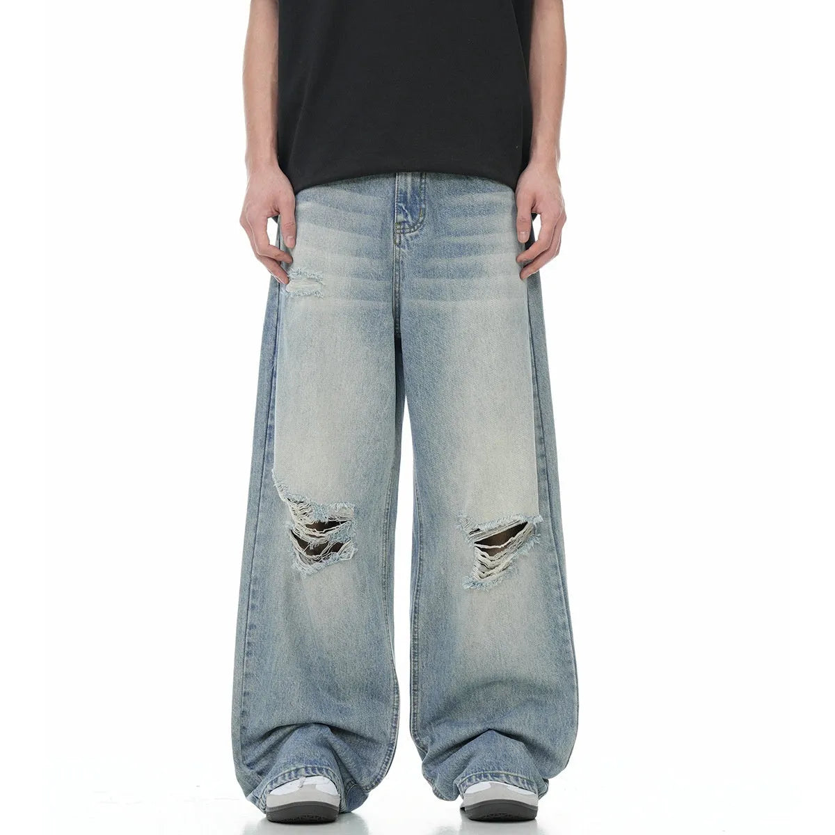 Blue men's straight-leg jeans with ripped distressing on the thigh, showing five-pocket design and zip fly.