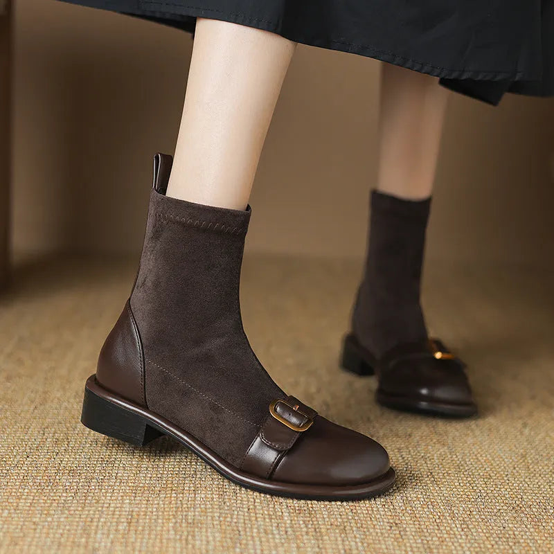 Black women's low heel martin boot with lace-up front and belt buckle stitching detail.