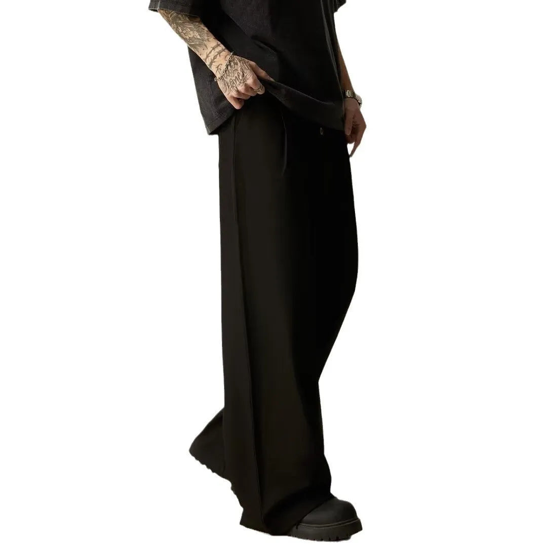 Men's black wide-leg casual trousers with elasticated mid waist and button fly in polyester-cotton blend fabric