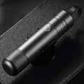 Gun grey aluminium automobile safety hammer with bearing steel impact head on a 3M rubber base next to a test glass piece.