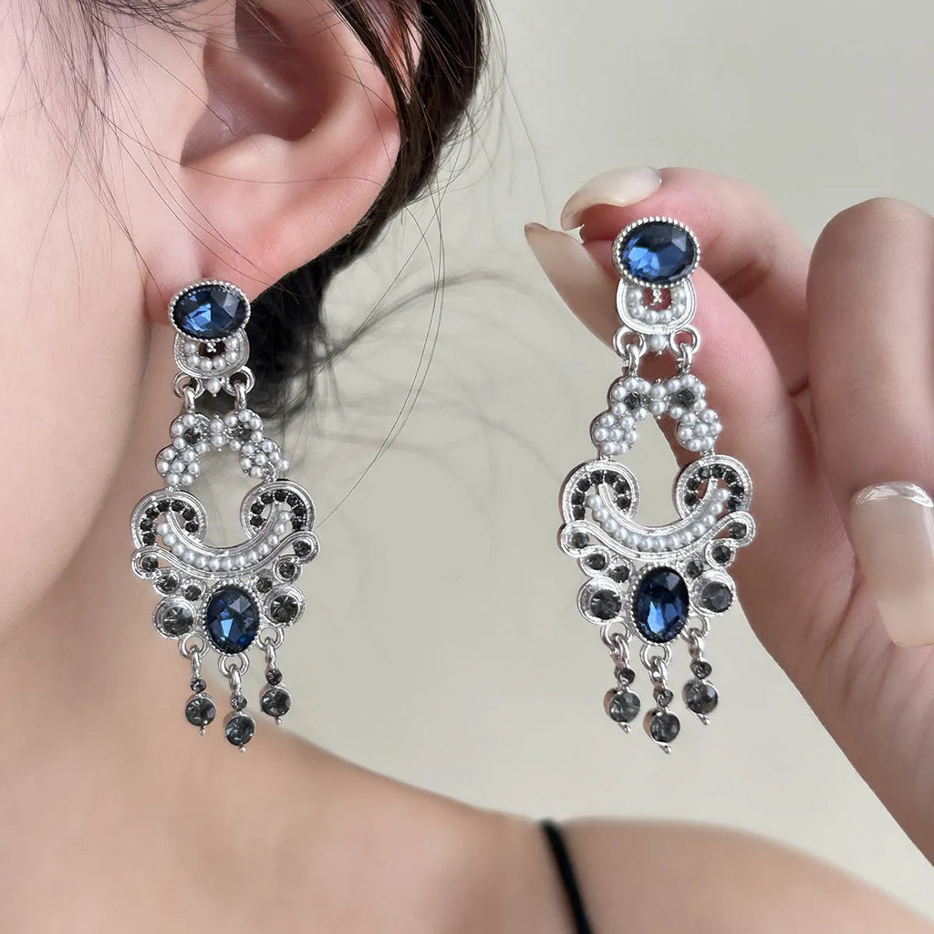 Vintage court style earrings with atmospheric blue crystal and chamfered square grain geometric shape in E7744 colour
